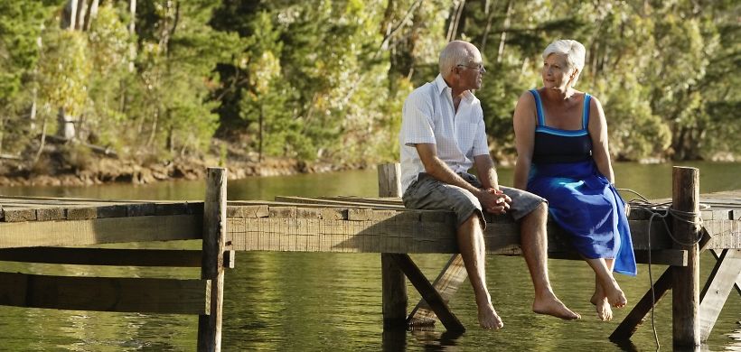 Älteres Ehepaar auf einem Steg am See