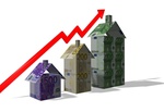 Aktienkurve mit Häusern aus Geld