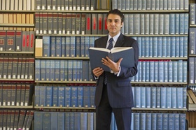 Hispanic businessman doing research in library