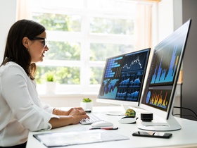 Analyst Women Looking At KPI Data On Computer Screen
