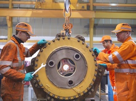 Engineer teaching apprentices in factory