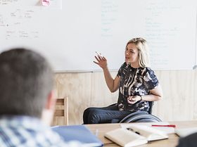 A photo of disabled businesswoman giving presentation. 
