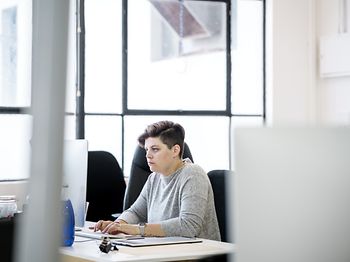 Businesswoman using computer at desk. Confident female profession