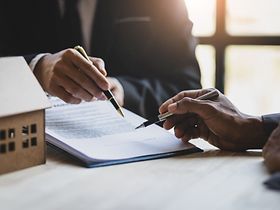 Businessmen and real estate agents discussing documents signing a