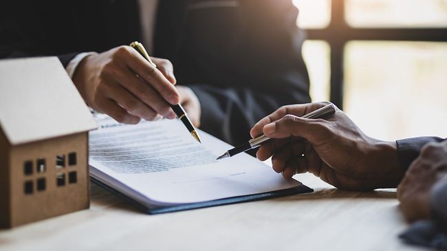 Businessmen and real estate agents discussing documents signing a