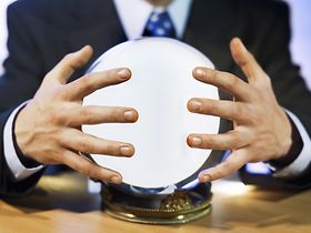Close-up mid section of man touching crystal ball