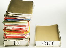 Close-up of empty out box and full in box
