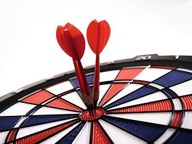 Dartscheibe mit Pfeilen im Zentrum