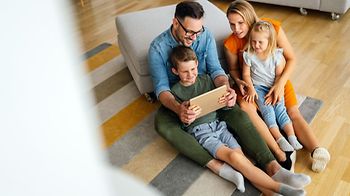 family fun time at home parents with children using tablet