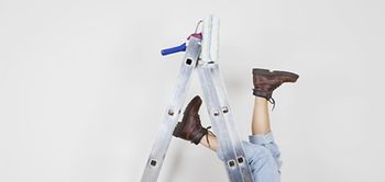 Frau die von Leiter gestürzt ist Leiter und Beine sichtbar