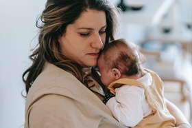 Frau hält Baby auf dem Arm