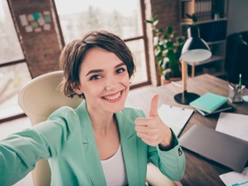 Close up photo of positive girl lawyer secretary collar make selfie, show thumb up sign approve star