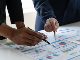 Asian businessman brainstorming to analyze financial reporting situation, investment, income, tax an