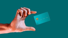 Close up male hand and levitating template mockup bank credit card with online service isolated on g