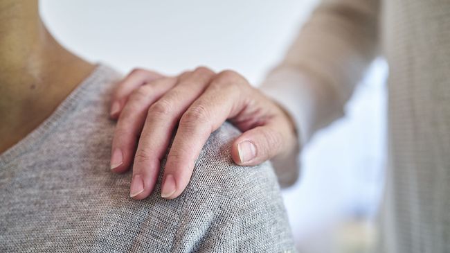 Hand auf Schulter