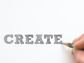 Hand mit Stift schreibt Create