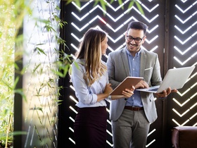 Happy business colleagues at meeting in modern office interior