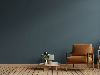 Dark blue living room interior with cozy leather armchair