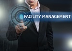 Businessman presses button facility management on virtual screens