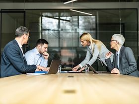 Young couple and their lawyers talking about the divorce during a