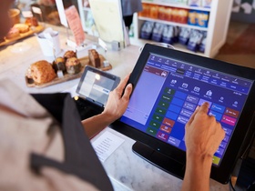 Close Up Of Female Employee Working At Delicatessen Checkout