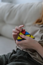 Kind spielt mit Zauberwürfel-Pyramide