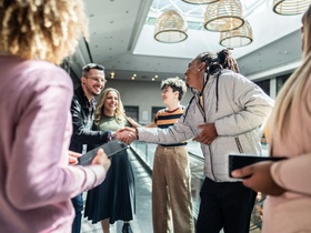 Coworkers greeting at office lobby