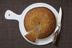 Kuchen und Kuchenstück auf Teller mit Messer