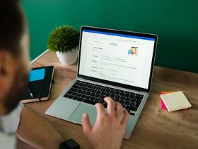 Mann arbeitet am Laptop am Lebenslauf