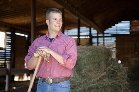 Farmer standing in a barn
