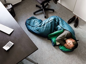 Mann schlafen im Büro Schlacksack