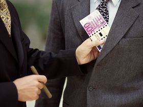 Mann steckt Partner Bündel Geldscheine in Jackentasche