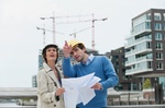 Germany, Hamburg, Man and woman with blueprint at harbour