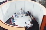 Business people meeting in round open plan conference room