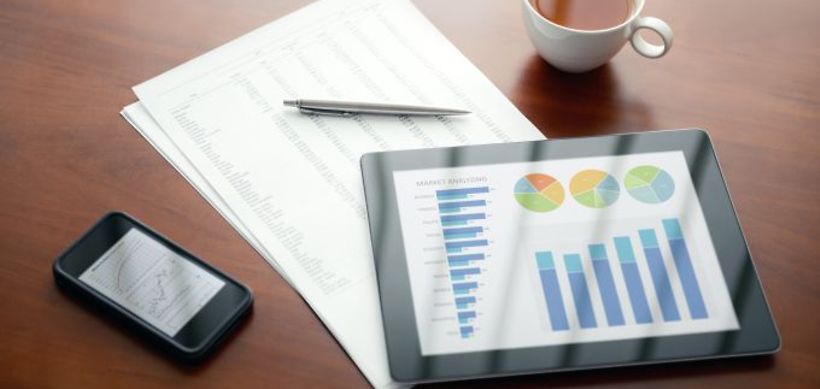 Modern workplace with digital tablet and mobile phone, pen and pa