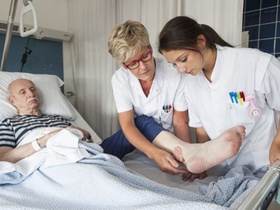 Pflegerinnen betreuen älteren Mann im Krankenhaus