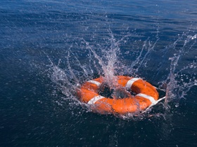 Round life preserver splashing into water