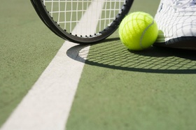 Tennis Ball and Racket on Court