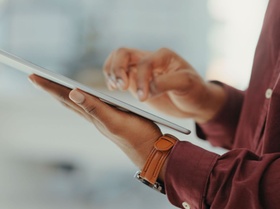 Closeup of man, tablet and hands in office for productivity, website planning and internet research.