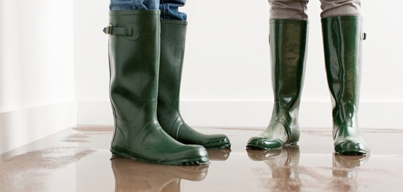 Young couple in wellington boots on flooded floor