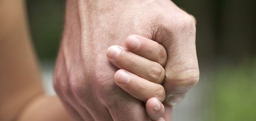 Vater mit Kind an der Hand