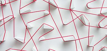 Vernetzung_roter Faden an weißen Klötzchen