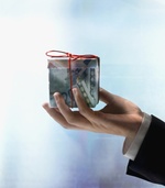 Businessman's hand holding gift box made of Euros