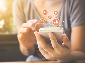 Woman hand using mobile smartphone with icon social media 