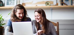 young couple laptop living room apartment
