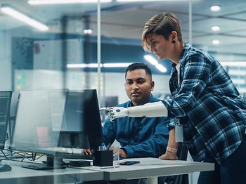 Teamwork In Office: Woman with Disability Prosthetic arm