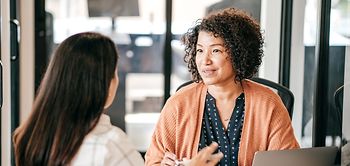 Two women discussing strategy
