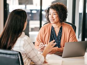 Two women discussing strategy